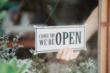 Open sign hanging in a window
