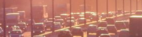 vehicles driving down four-lane highway in bumper to bumper traffic